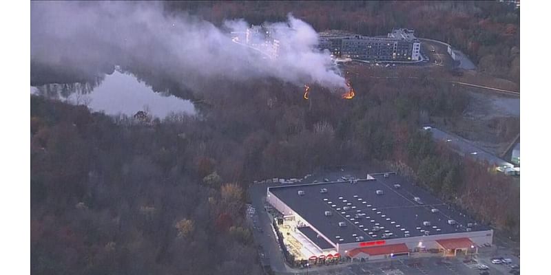 Brush fire burning near Home Depot, apartment complex on Route 1 in Saugus