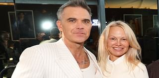 Robbie Williams matches outfits with Pamela Anderson in white suit at Deadline Contenders Film event - after revealing he was threatened to be kicked out of Take That aged 16