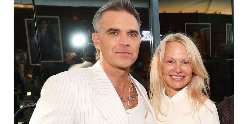 Robbie Williams matches outfits with Pamela Anderson in white suit at Deadline Contenders Film event - after revealing he was threatened to be kicked out of Take That aged 16