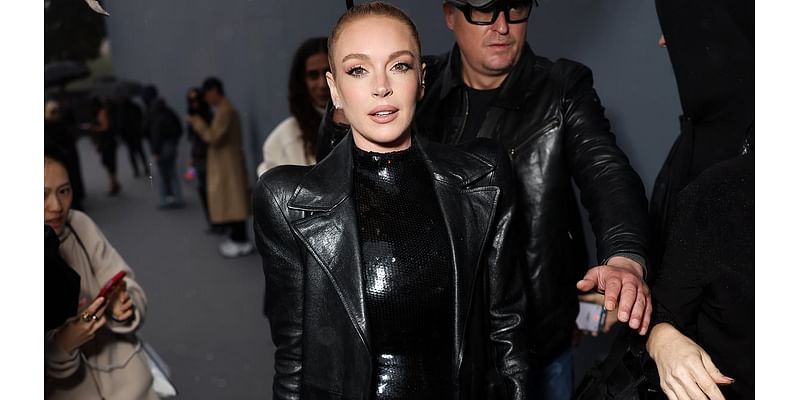 Lindsay Lohan poses up a storm in a black sequin dress at Balenciaga show during Paris Fashion Week