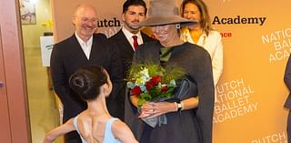 Queen Maxima braves the rain in a fabulous wide-brimmed hat to visit the National Ballet Academy