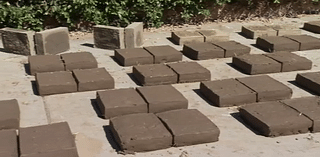 Fresno State students and staff learning how to make adobe bricks from expert