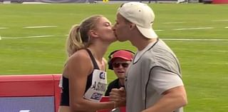 German track star Alicia Schmidt, dubbed 'the world's sexiest athlete', goes public with her photographer boyfriend as they share a kiss after her race