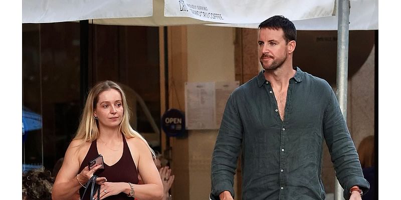 Australian swimming champion James Magnussen's fiancée Rose McEvoy shows off her huge diamond ring as they step out together in Sydney