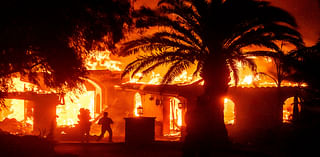 Strong winds push wildfire through Southern California community, burning dozens of homes