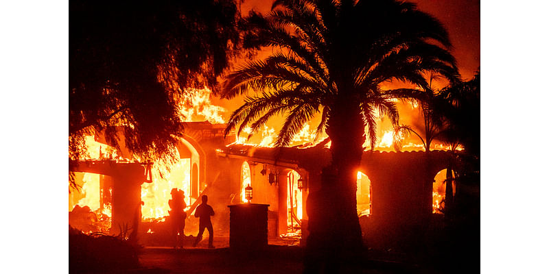 Strong winds push wildfire through Southern California community, burning dozens of homes