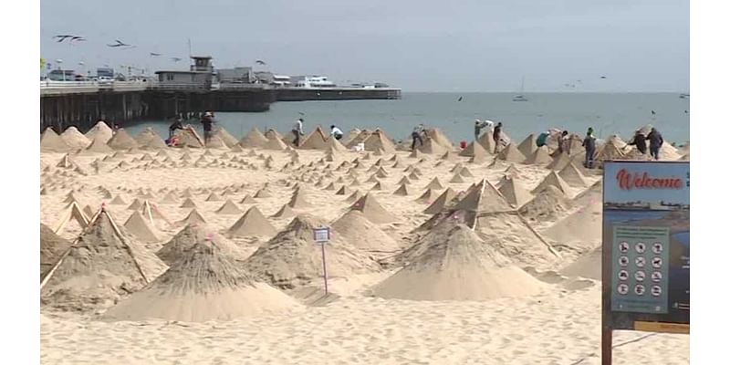 son duo build hundreds of pyramids on beach