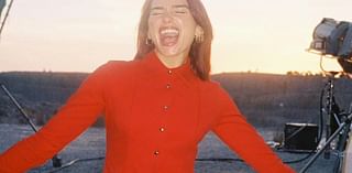 Dua Lipa ignores backlash over tour tickets as she poses in red pants and tights and says she’s ‘so happy’