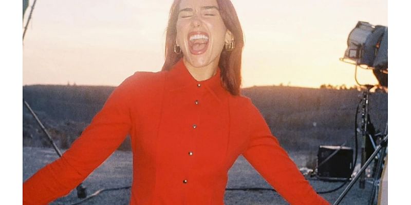 Dua Lipa ignores backlash over tour tickets as she poses in red pants and tights and says she’s ‘so happy’