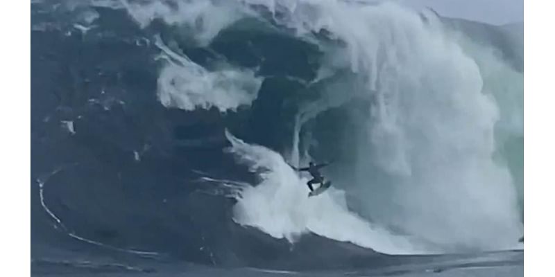 Terrifying moment surfer is wiped out by giant wave but miraculously survives