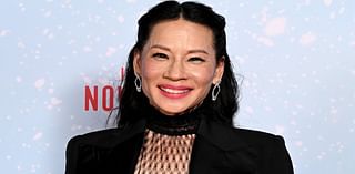 Lucy Liu flashes her legs in sheer tights as she joins Dwayne 'The Rock' Johnson at Red One screening