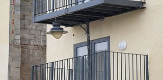 Developer builds balcony at block of flats around street lamppost