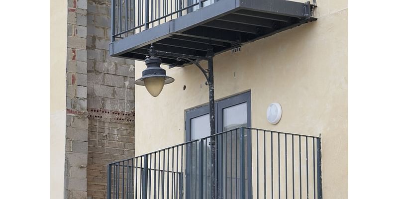 Developer builds balcony at block of flats around street lamppost