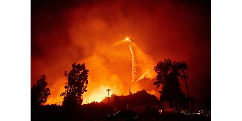 Strong winds push wildfire through Southern California community, burning dozens of homes