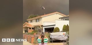 Smoke towers over homes as wildfire spreads near Los Angeles