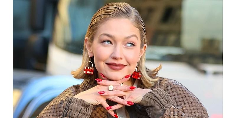 Gigi Hadid turns heads in a red rugby shirt and a trendy bomber jacket as she films glamorous Maybelline advert in the street in New York City