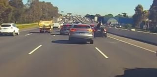 Motorcyclist's one-in-a-million escape from death after heart-stopping footage emerges of serious crash on Sydney's M5 Motorway