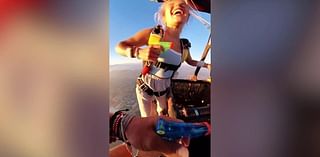 Skydiving couple have water gun fight 5,000 feet in air