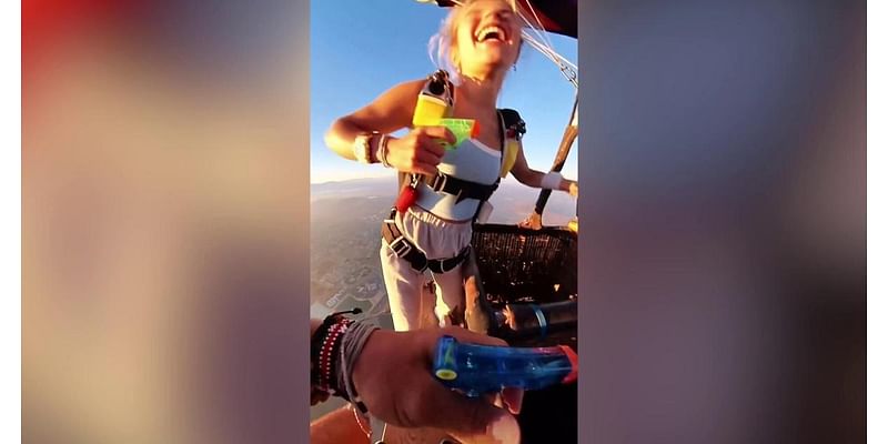 Skydiving couple have water gun fight 5,000 feet in air