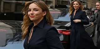 Jodie Comer looks effortlessly classy in a plunging navy blue shirt and midi skirt as she heads to Gabriela Hearst's runway show for Paris Fashion Week