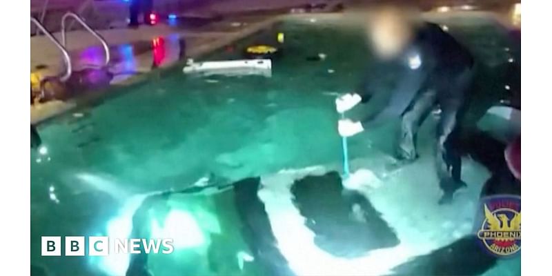 Moment police officer rescues man trapped in submerged car