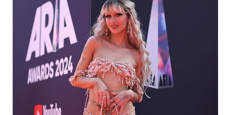 Pop star Peach PRC almost suffers a wardrobe malfunction as her crochet outfit perilously hangs off her slender frame at the 2024 ARIA Awards