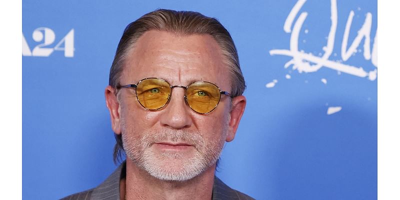 Daniel Craig appears to be morphing into U2's Bono with yellow sunglasses and slicked-back hair as he attends Queer premiere in LA