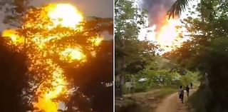 Frightening moment 'mud volcano' erupts in towering flame as terrified onlookers run for their lives