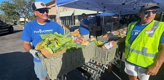 Volunteers help distribute free groceries at Tangerine Plaza in St. Pete