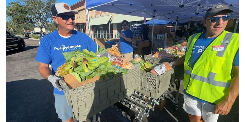 Volunteers help distribute free groceries at Tangerine Plaza in St. Pete