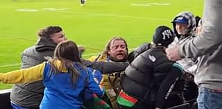 See the moment furious footy fans call security guards 'clowns' as they accuse man of getting into a fight in wild scenes at NRL match