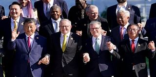 Cringe moment G20 leaders including Keir Starmer and China's communist autocrat Xi Jinping HOLD HANDS for cheesy 'family photo' in Rio - but walkabout US president Biden is MIA