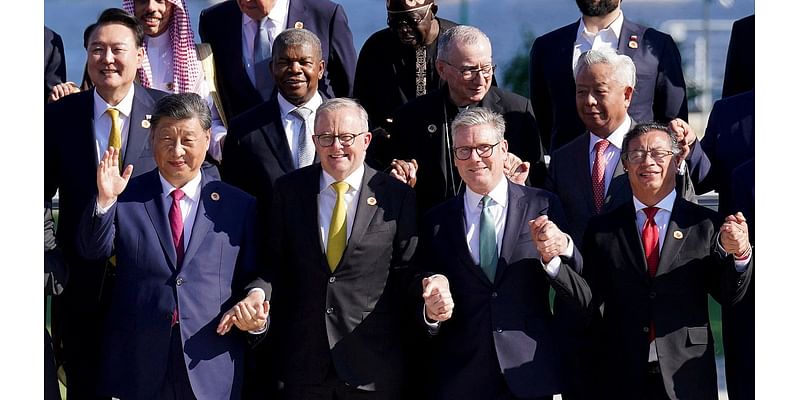 Cringe moment G20 leaders including Keir Starmer and China's communist autocrat Xi Jinping HOLD HANDS for cheesy 'family photo' in Rio - but walkabout US president Biden is MIA