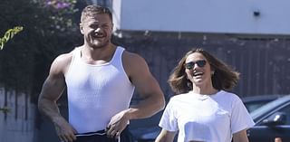 Imagine Dragons' Dan Reynolds shows off bulging biceps as he wraps arms around Minka Kelly in LA