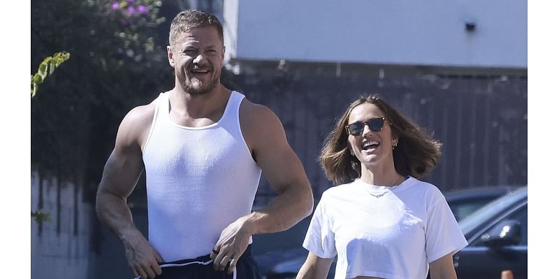 Imagine Dragons' Dan Reynolds shows off bulging biceps as he wraps arms around Minka Kelly in LA