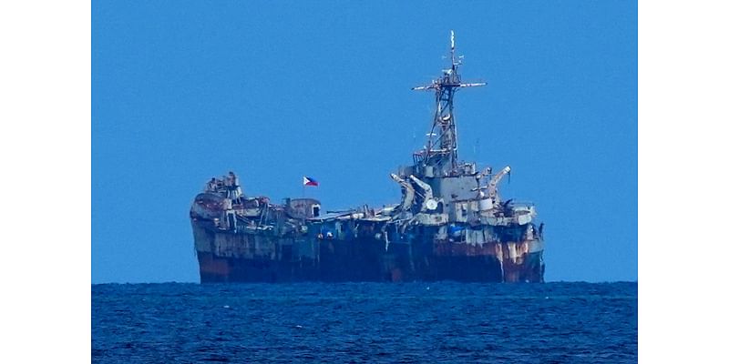 Chinese and Philippine forces again avoid a clash in a fiercely disputed shoal under a rare deal