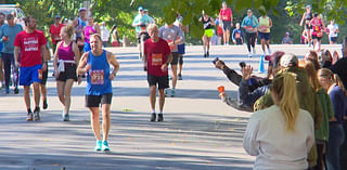 Volunteers and "Runtourage" members help get Twin Cities Marathoners across the finish line