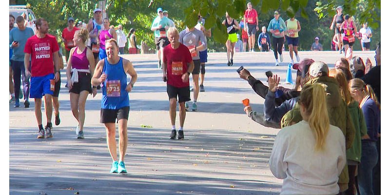 Volunteers and "Runtourage" members help get Twin Cities Marathoners across the finish line