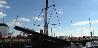 Crane straps give way in East Boston, sending floating pier crashing onto boat, marina