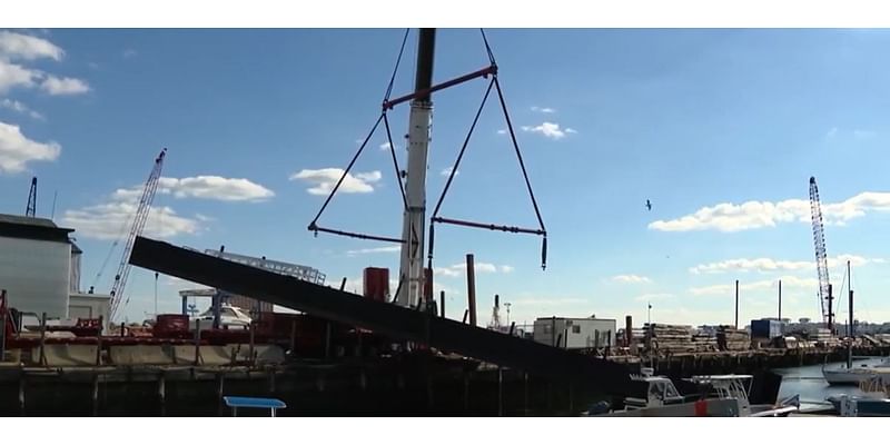 Crane straps give way in East Boston, sending floating pier crashing onto boat, marina