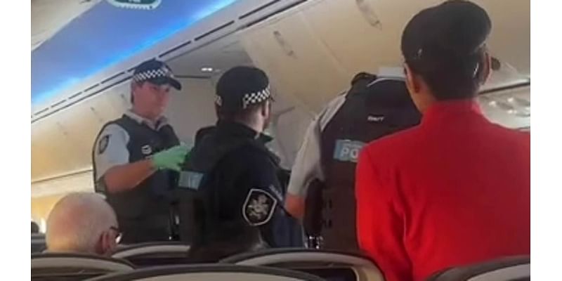 Drunken Jetstar passenger is kicked off the plane by cops after 'shouting racist abuse at flight staff'