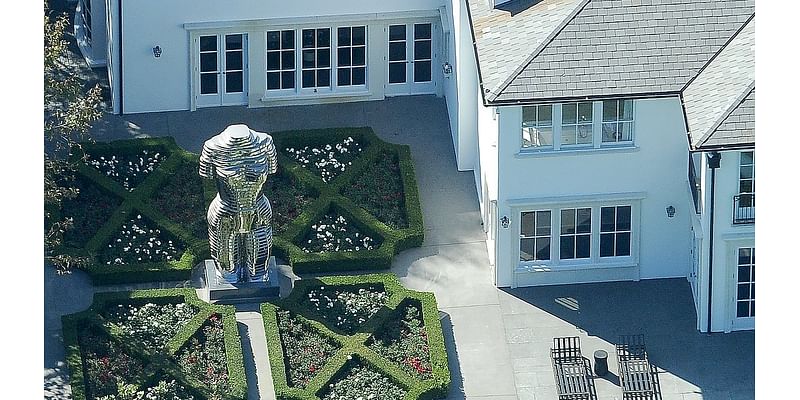 Aerial photos show Diddy's 20-foot statue memorializing Kim Porter and her 'little badonkadonk' at his Los Angeles mansion as he languishes in jail