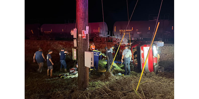 Female extricated from vehicle after collision with train