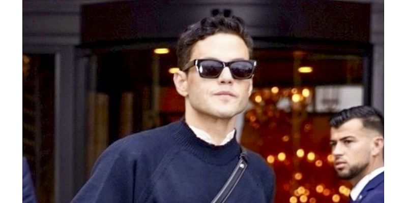 Rami Malek cuts a suave figure as he steps out ahead of Paris Fashion Week - after sparking engagement rumours with partner Emma Corrin