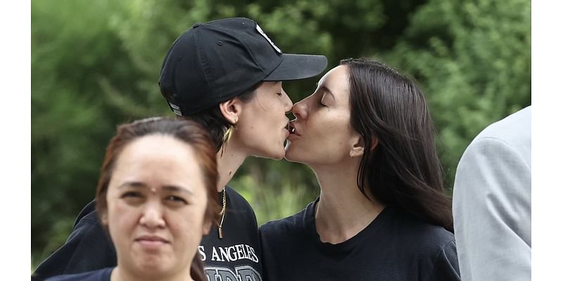 The Veronicas singer Jess Origliasso shares a sweet smooch with fiancée Alex Smith at Sydney Airport as the couple arrive in Australia