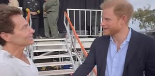 Awkward moment Richard Marx almost ignores Prince Harry at Kevin Costner's charity event - as 'sick' Meghan Markle stays home