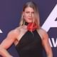 Christian Wilkins shows off his muscular frame in a glam black flower dress as he joins Lucia Hawley leading the stars at the 2024 ARIA Awards