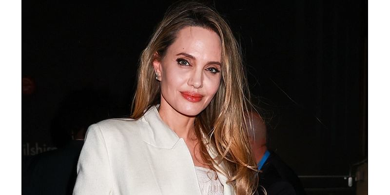 Angelina Jolie covers up her over 20 tattoos in a crisp white suit as she attends a Maria screening in Los Angeles