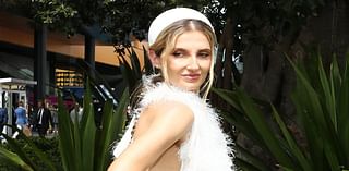 Kate Waterhouse puts on a quirky display in an elegant white feathered gown as she joins Grace Hayden leading the stars at Royal Randwick's Everest race day in Sydney