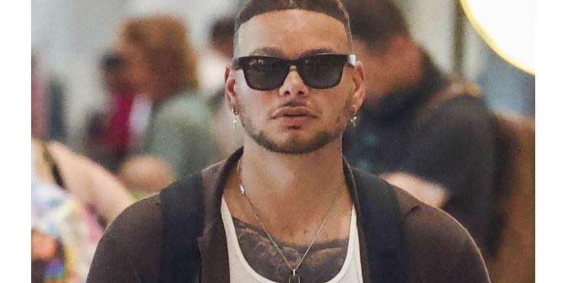 US music star goes incognito as he touches down in Sydney amid his Australian tour